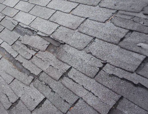 a minnesota house roof with hail damage being repaired by Donnelly Stucco & Exteriors